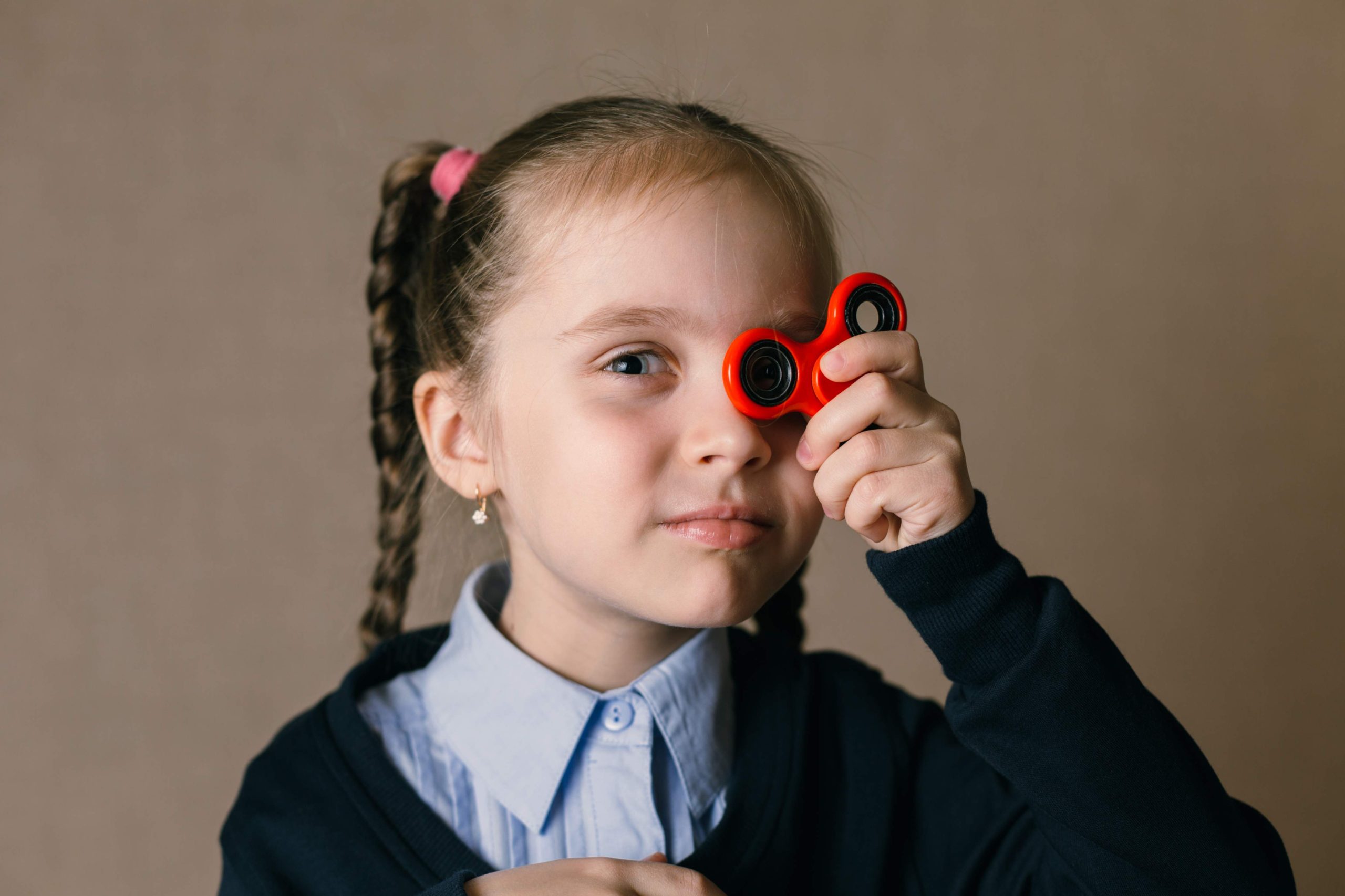 jpeg optimizer little girl with fidget spinner held up his eyes scaled